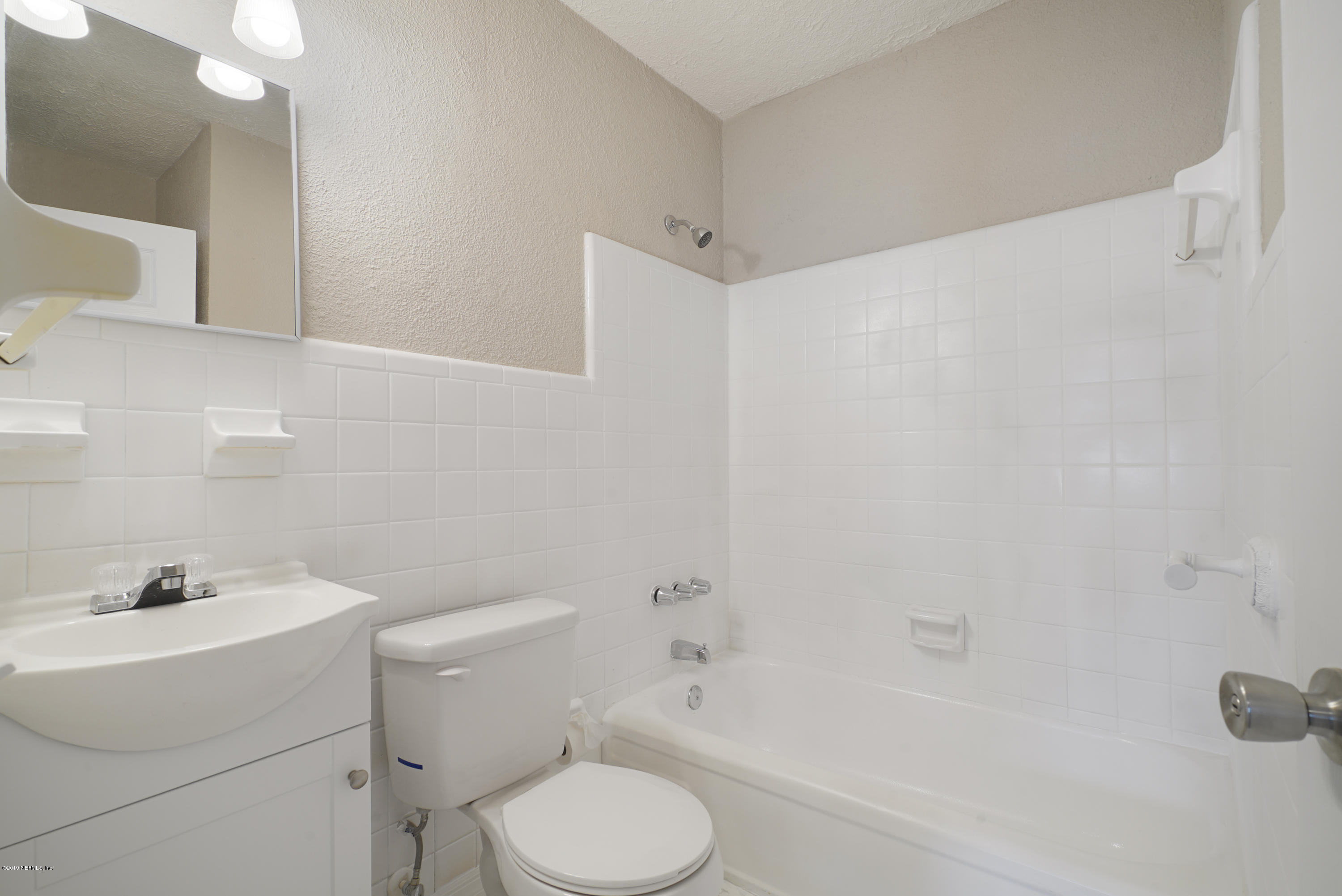 4714 Dundee Road Jacksonville, FL 32210 - Photo 17 of 22 a bathroom with a sink toilet and shower