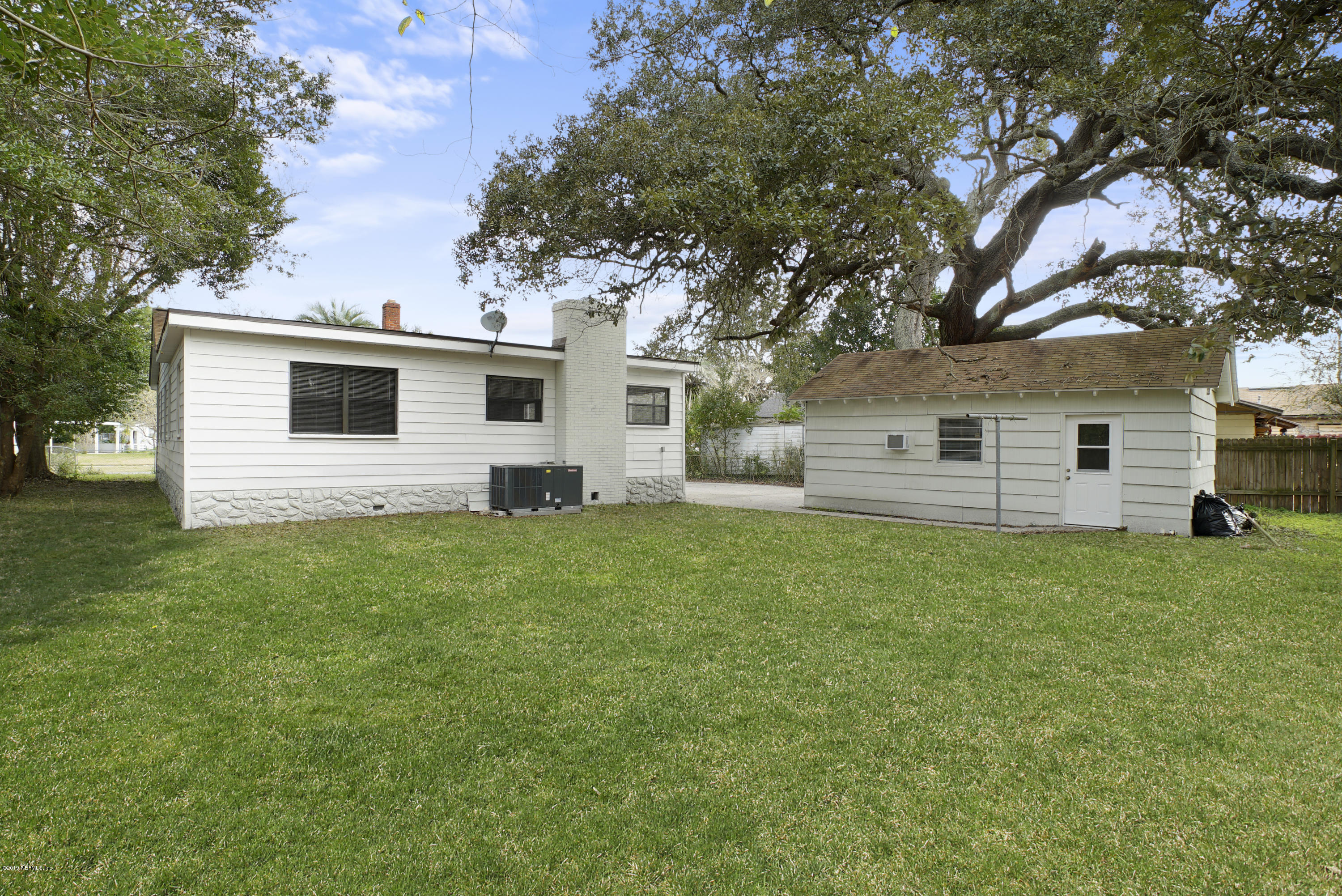 4714 Dundee Road Jacksonville, FL 32210 - Photo 19 of 22 a front view of house with yard and green space
