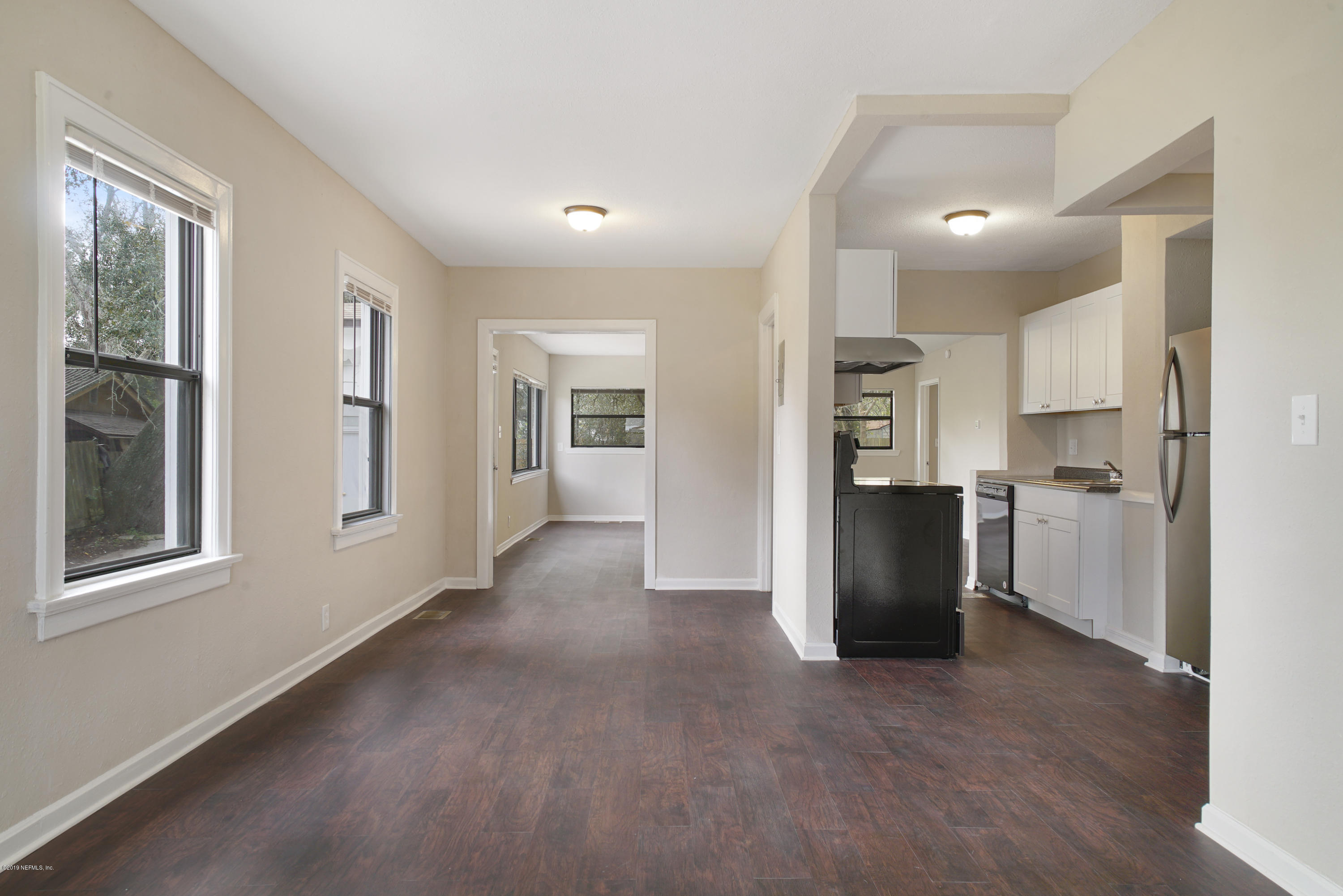 4714 Dundee Road Jacksonville, FL 32210 - Photo 3 of 22 a view of a kitchen with refrigerator and windows