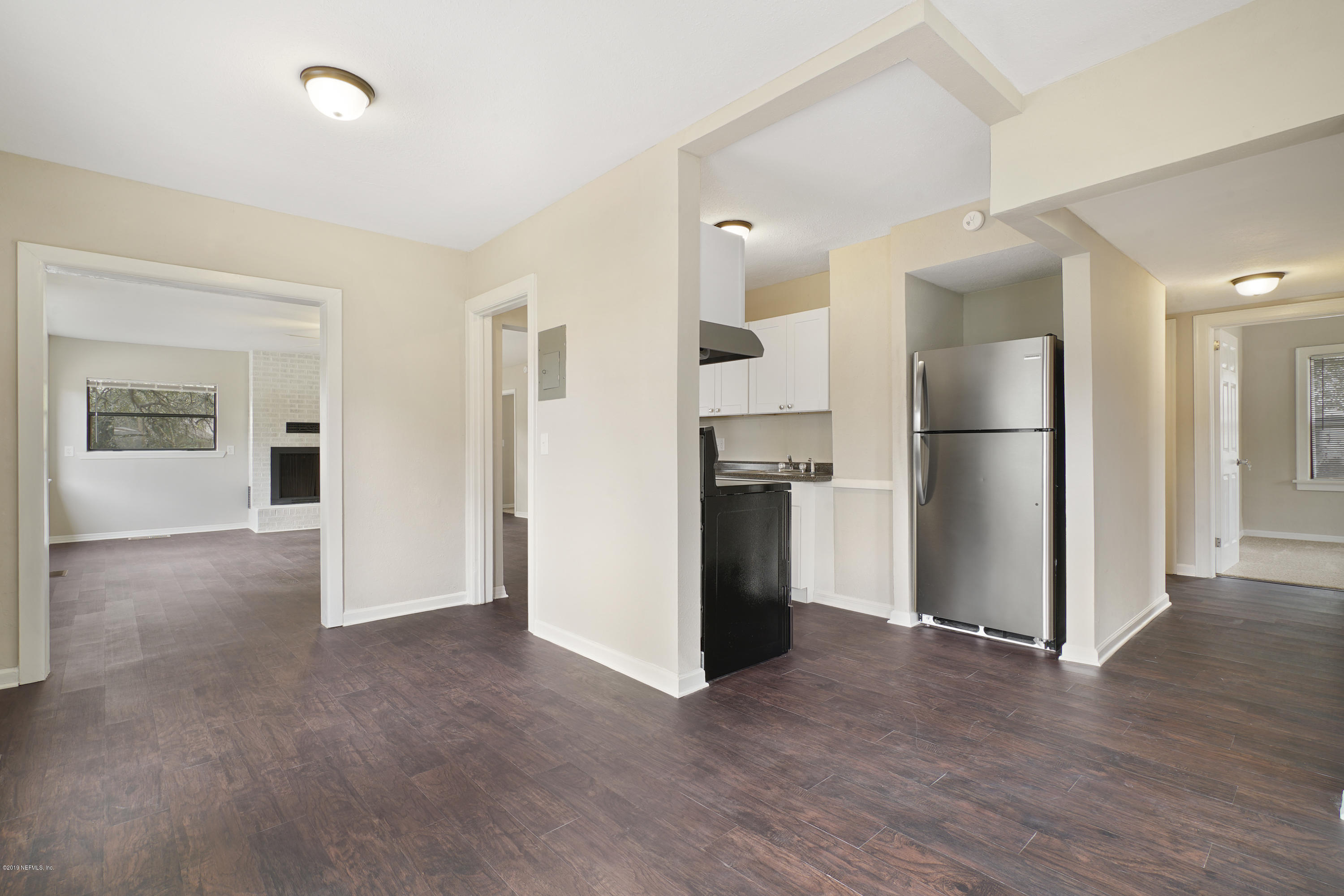 4714 Dundee Road Jacksonville, FL 32210 - Photo 4 of 22 a view of a kitchen with a refrigerator and a stove top oven