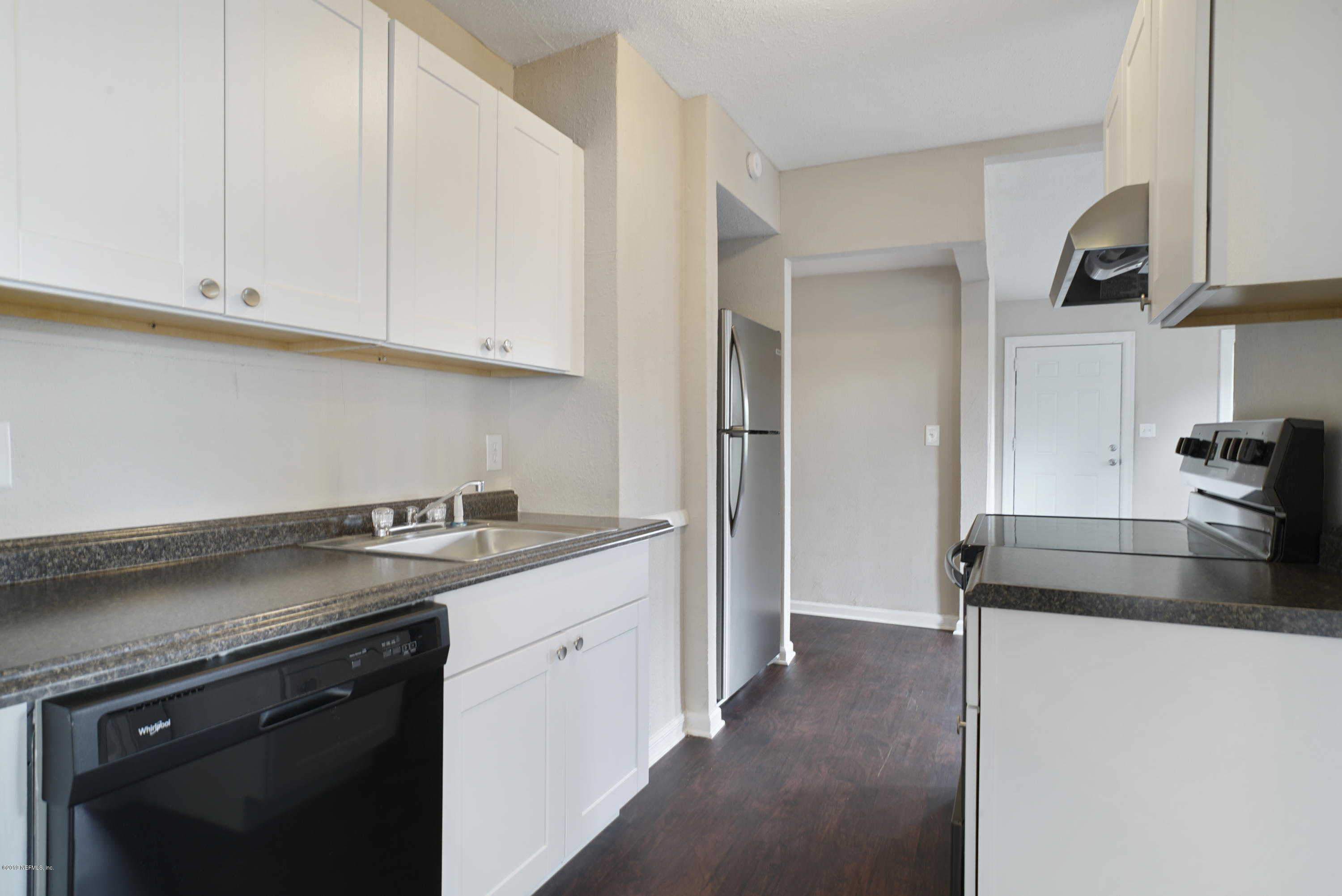 4714 Dundee Road Jacksonville, FL 32210 - Photo 5 of 22 a kitchen with a sink and a stove top oven