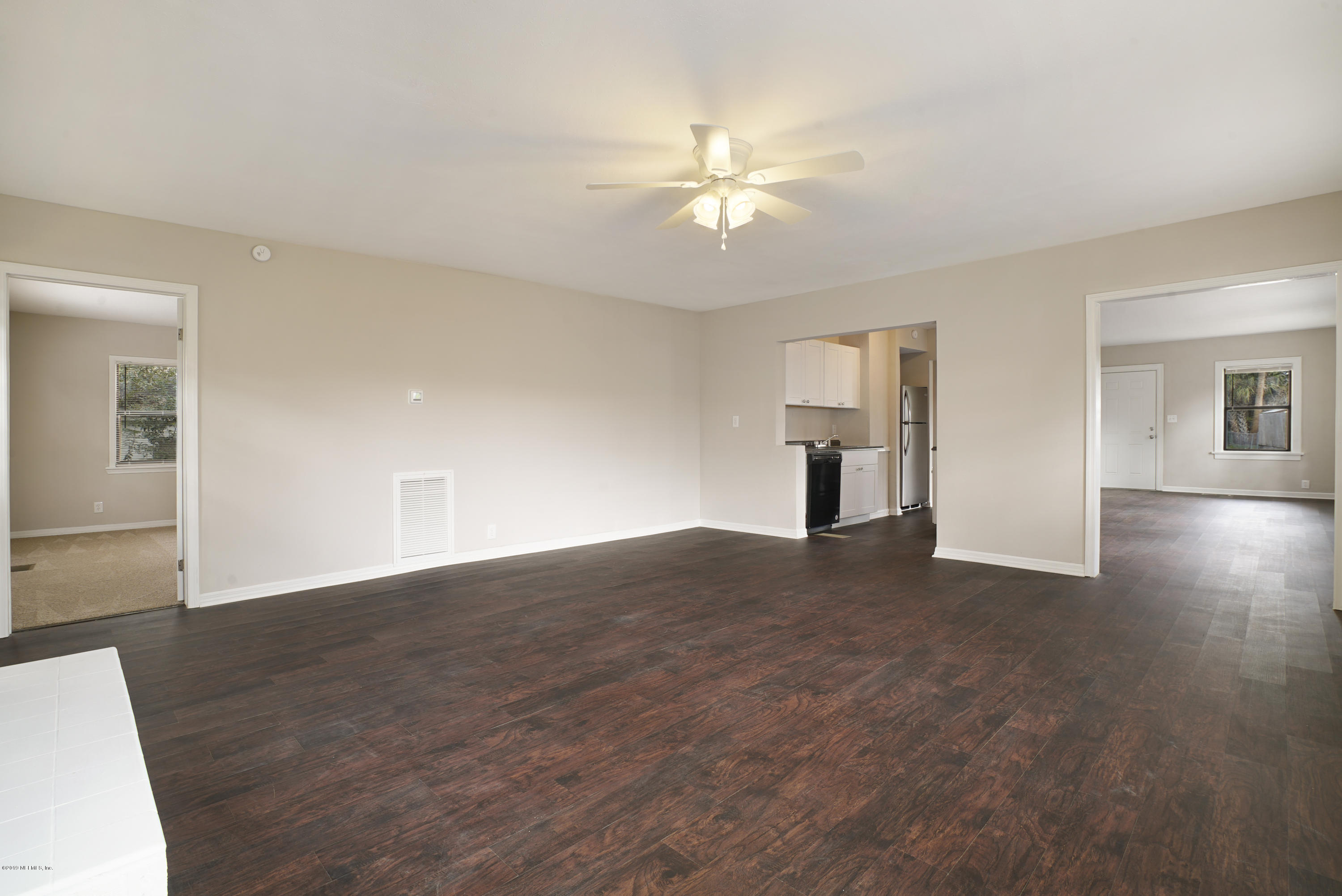 4714 Dundee Road Jacksonville, FL 32210 - Photo 9 of 22 a view of empty room with wooden floor