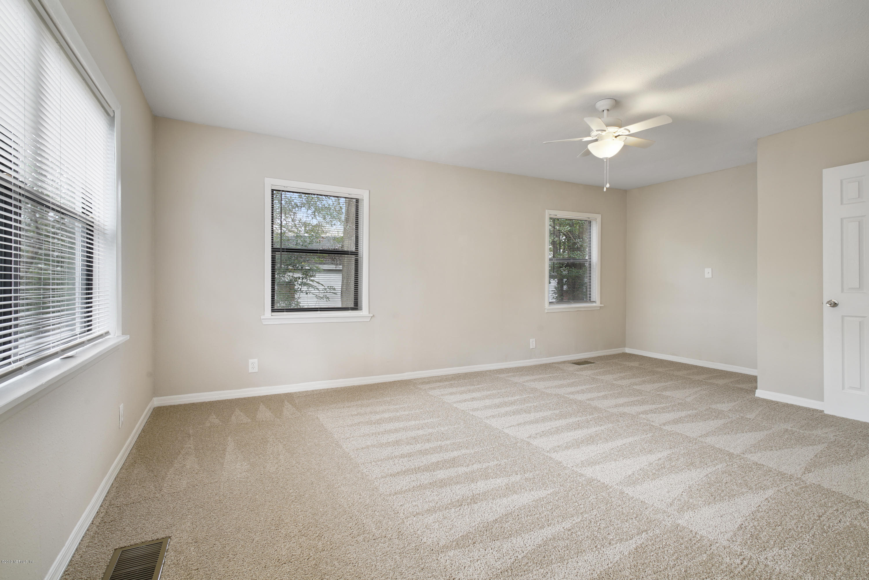 4714 Dundee Road Jacksonville, FL 32210 - Photo 10 of 22 a view of an empty room with a window
