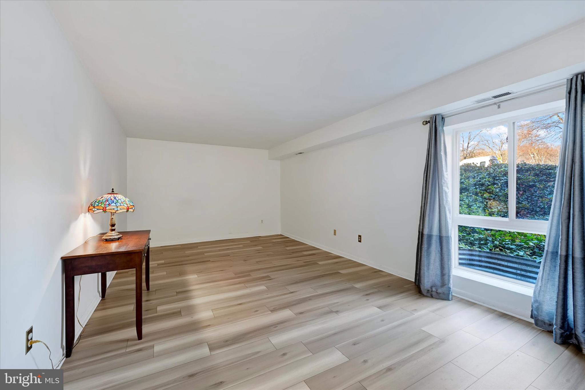 13139 Dairymaid Drive, Unit 99/T1 Germantown, MD 20874 - Photo 12 of 17 a view of room with window and wooden floor
