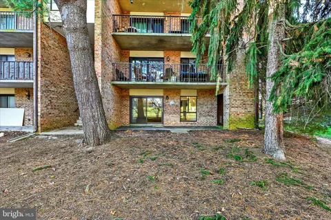 a view of a house with a yard and tree s