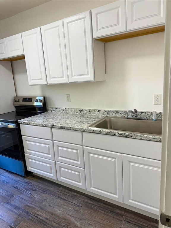 232 Pequoig Avenue, Unit 2 Athol, MA 01331 - Photo 5 of 17 a kitchen with granite countertop white cabinets and a stove