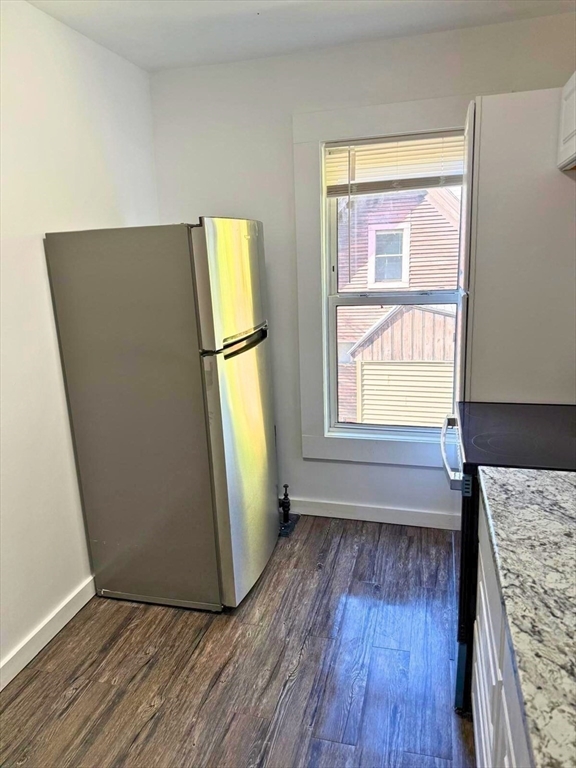 232 Pequoig Avenue, Unit 2 Athol, MA 01331 - Photo 6 of 17 a view of an empty room with wooden floor and a window