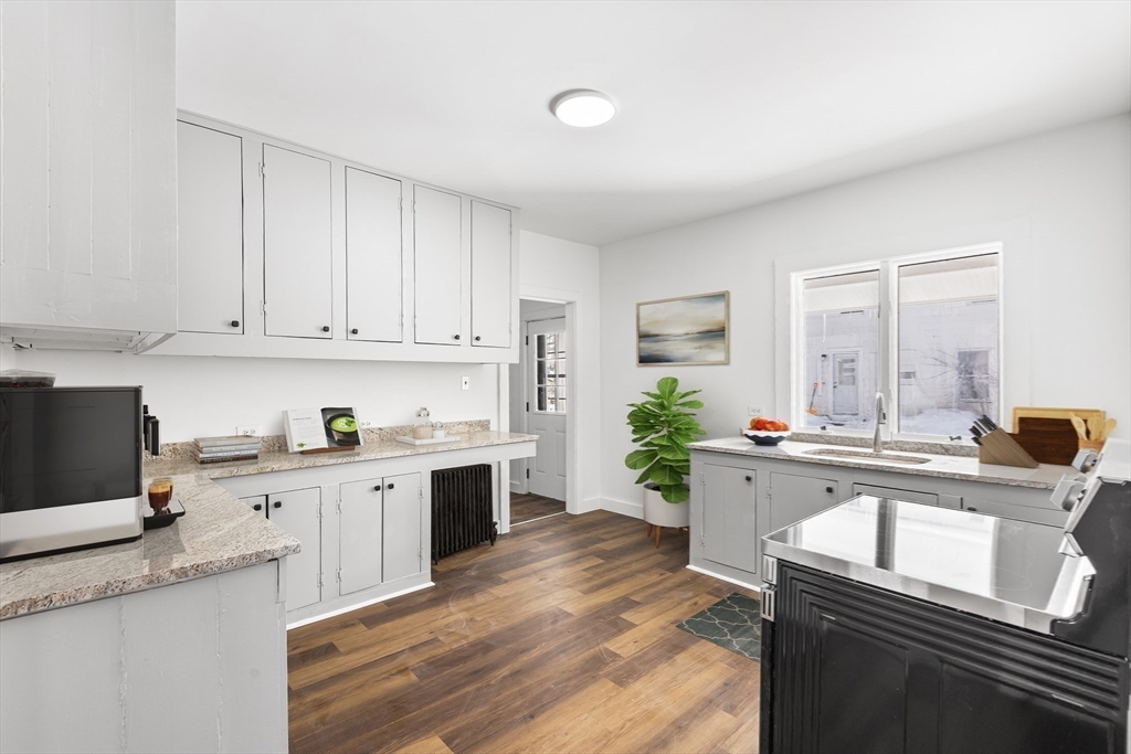 232 Pequoig Avenue, Unit 2 Athol, MA 01331 - Photo 7 of 17 a kitchen with a sink stove and cabinets