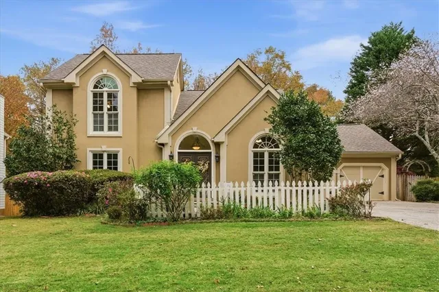 a front view of a house with a garden
