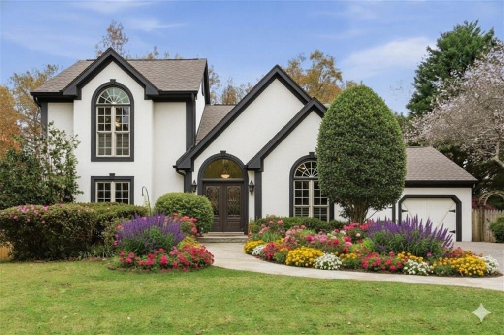 a front view of a house with a garden and plants