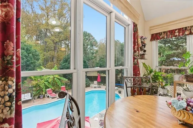a living room with furniture a fireplace and a chandelier