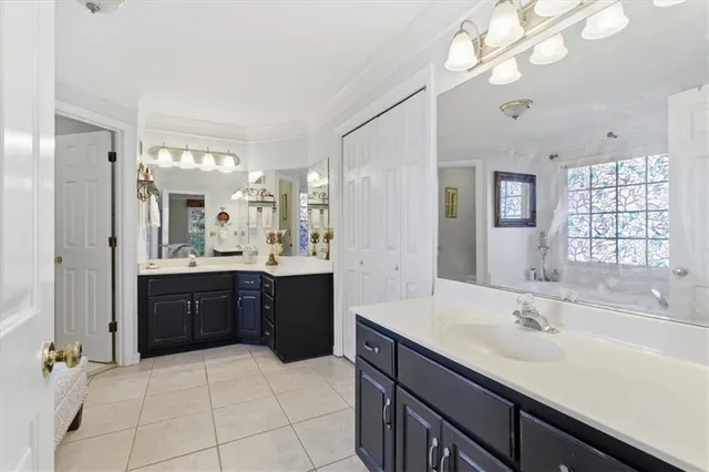 a bathroom with double vanity sink a toilet and a mirror