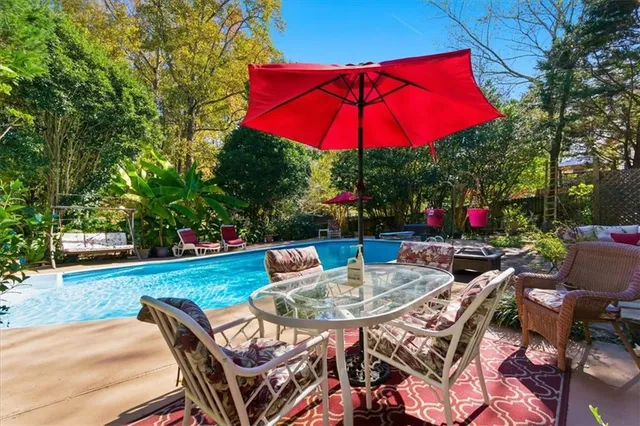 a front view of a house with yard patio and green space