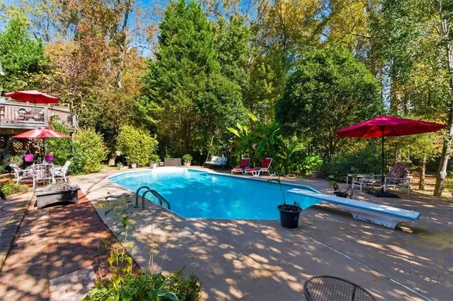 a kitchen with granite countertop a refrigerator stove and sink