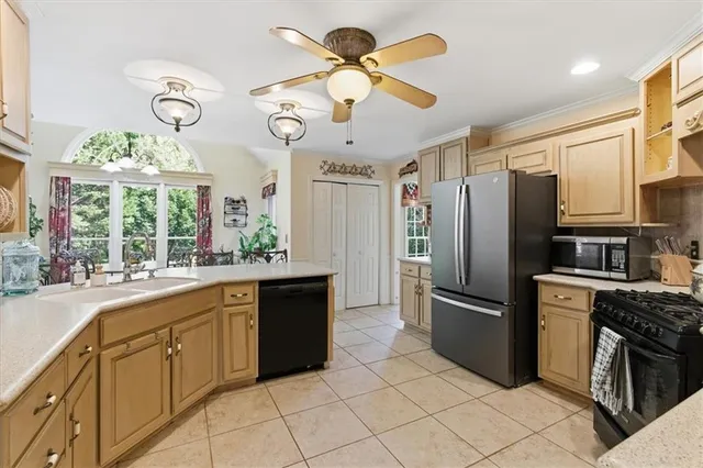 a kitchen with stainless steel appliances a stove refrigerator sink and cabinets