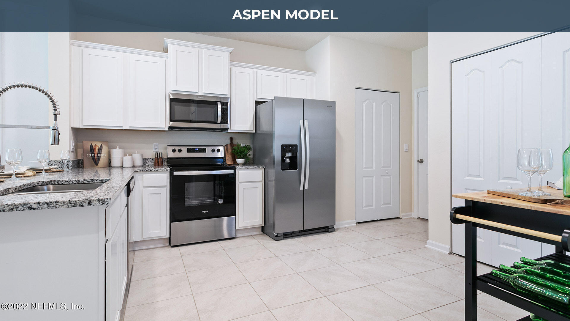 a kitchen with stainless steel appliances granite countertop a stove refrigerator and a microwave