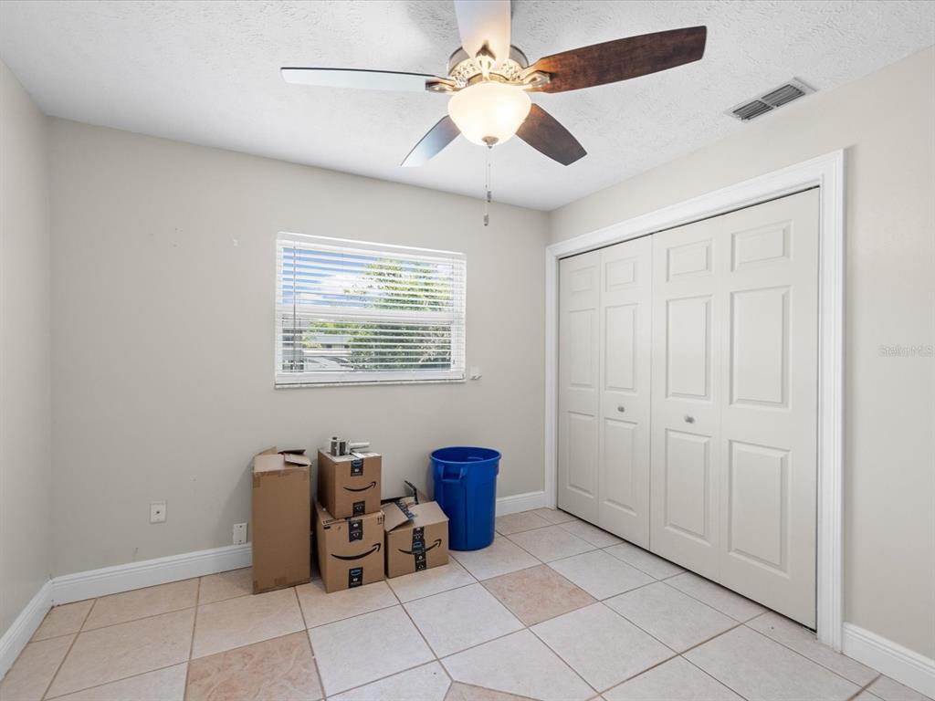 5904 Springrun Court Holiday, FL 34690 - Photo 34 of 53 a living room with furniture and a ceiling fan