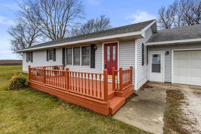 a view of a house with a yard and deck