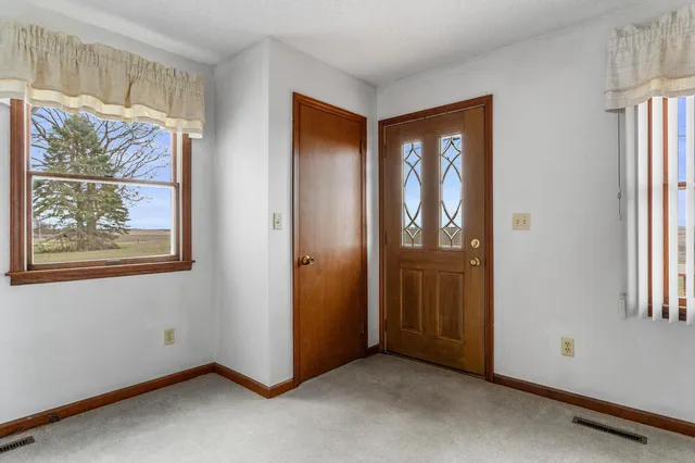 an empty room with windows and closet