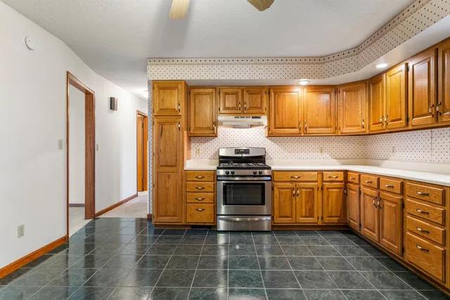 a kitchen with stainless steel appliances a stove a sink and a microwave