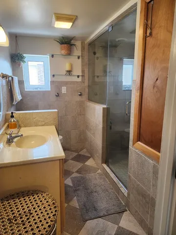 a bathroom with a sink toilet and shower