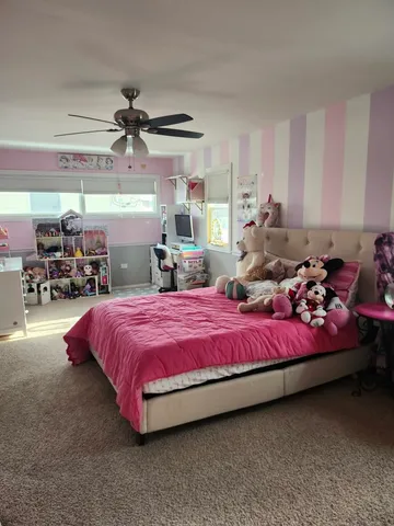 a bedroom with bed and window