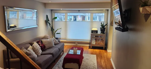 a living room with furniture and a floor to ceiling window