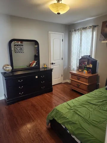 a bedroom with a bed and a dresser