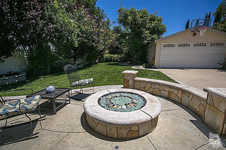25162 De Wolfe Road Newhall, CA 91321 - Photo 22 of 27 a view of a house with backyard sitting area and swimming pool