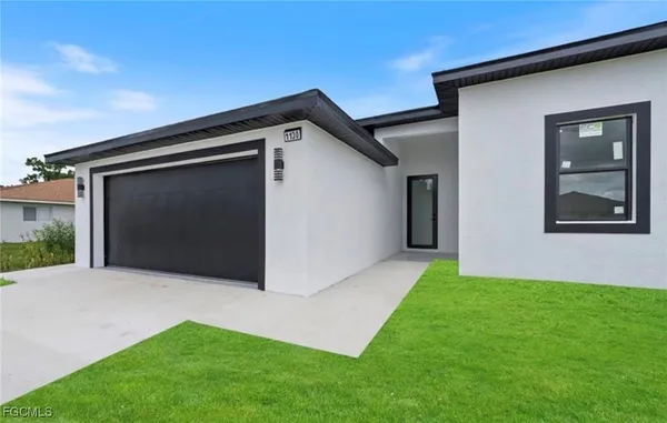 a front view of a house with a yard and garage