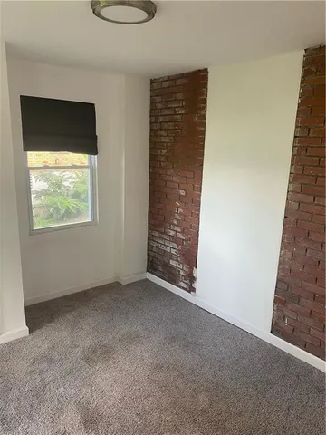 a view of an empty room with windows