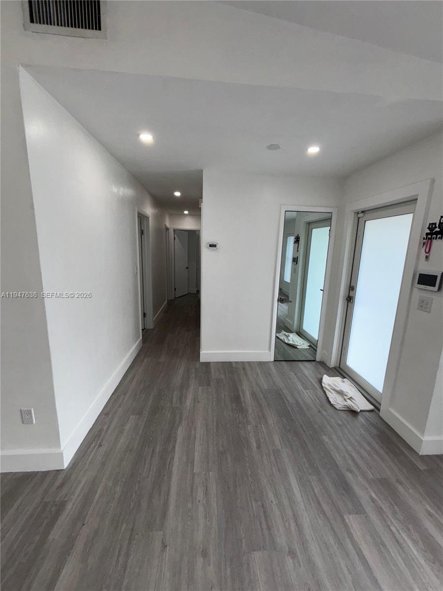 11105 Southwest 156th Terrace Miami, FL 33157 - Photo 11 of 23 wooden floor in an empty room with a window