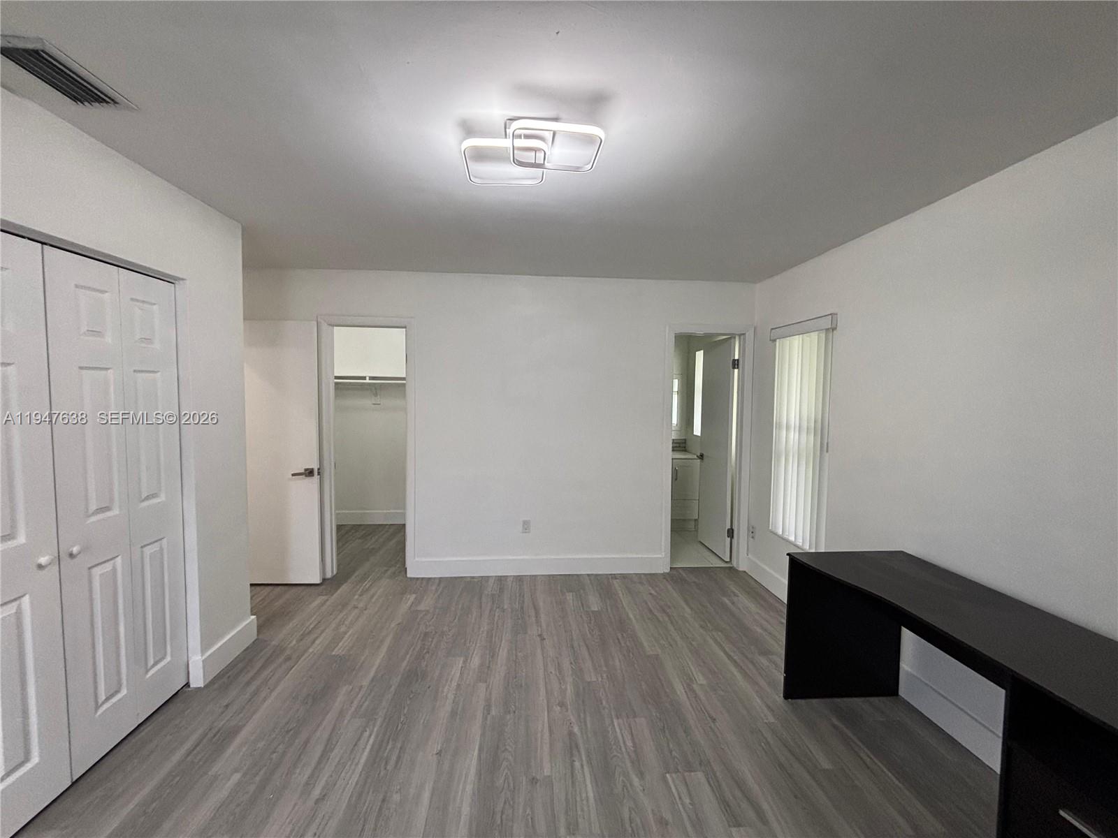 11105 Southwest 156th Terrace Miami, FL 33157 - Photo 22 of 23 wooden floor in an empty room with a window