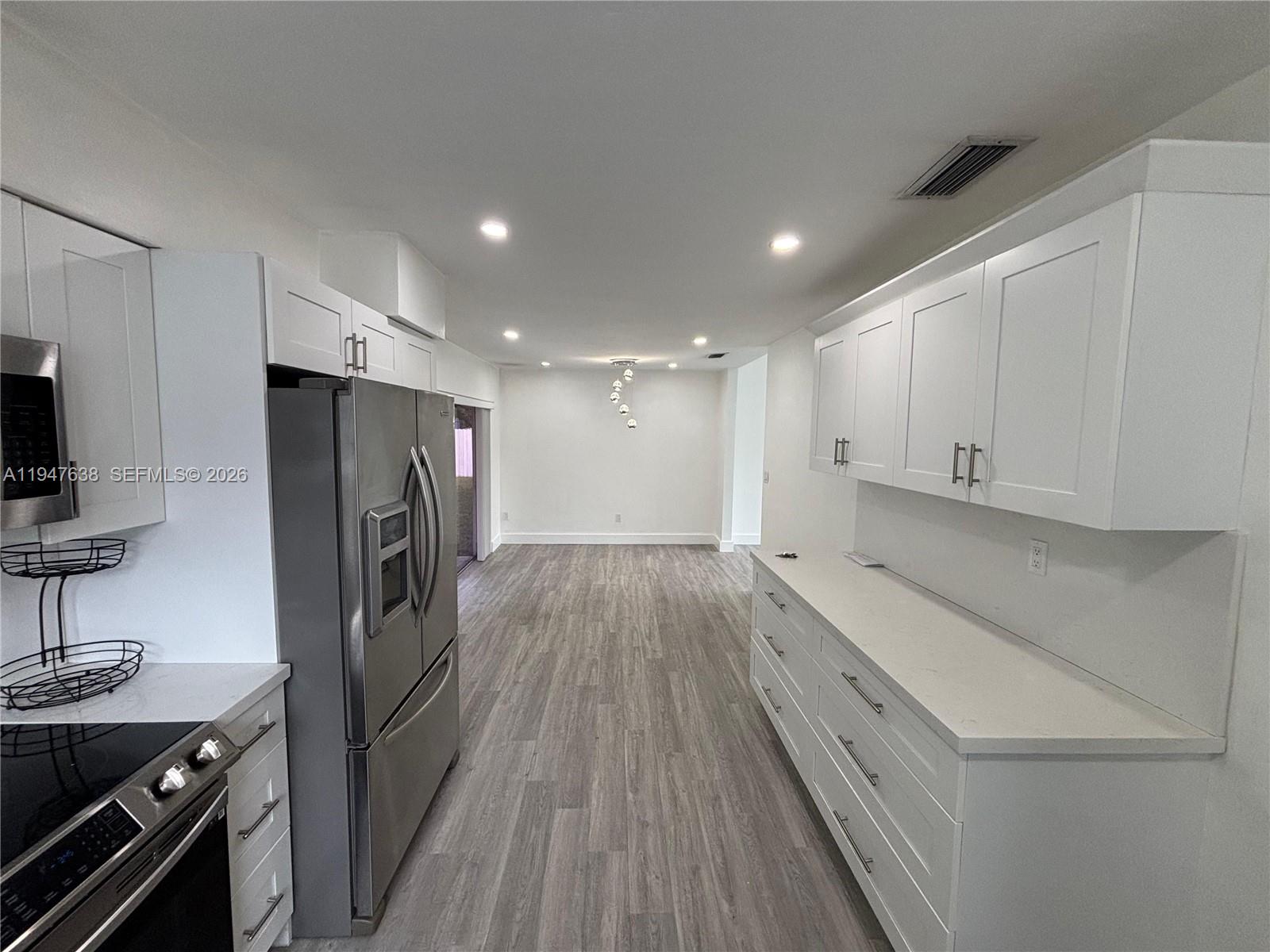 11105 Southwest 156th Terrace Miami, FL 33157 - Photo 3 of 23 a kitchen with a refrigerator and a stove top oven