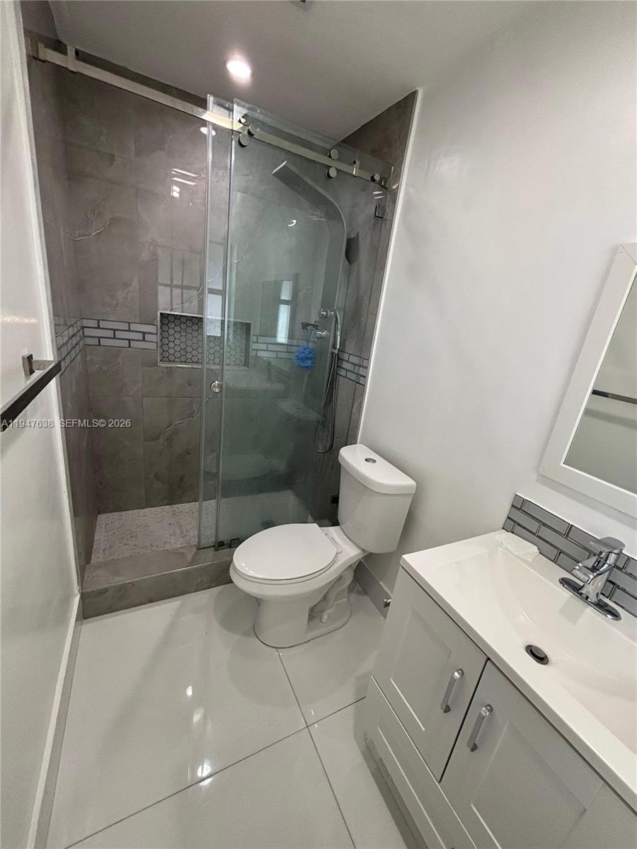 11105 Southwest 156th Terrace Miami, FL 33157 - Photo 4 of 23 a bathroom with a shower a toilet and a sink