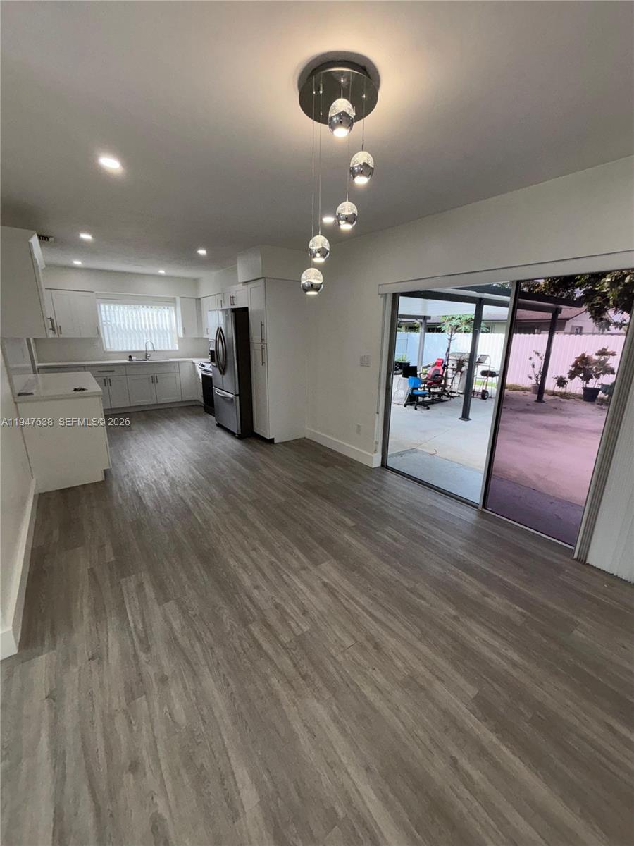 11105 Southwest 156th Terrace Miami, FL 33157 - Photo 5 of 23 an empty room with wooden floor and windows