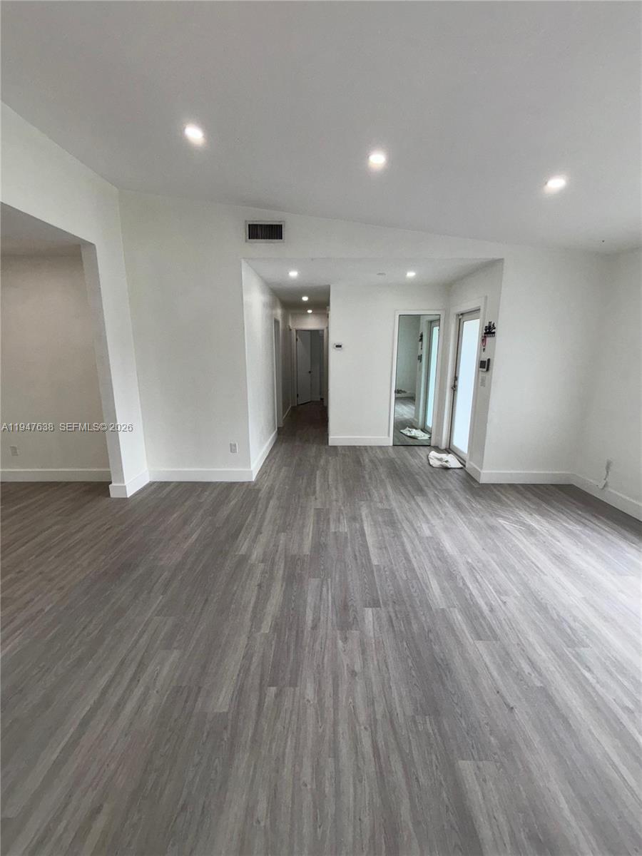 11105 Southwest 156th Terrace Miami, FL 33157 - Photo 9 of 23 an empty room with wooden floor and windows