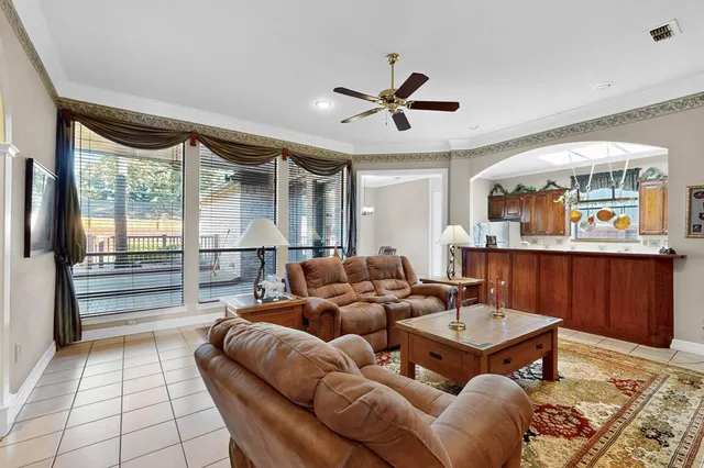 a living room with furniture ceiling fan and a rug