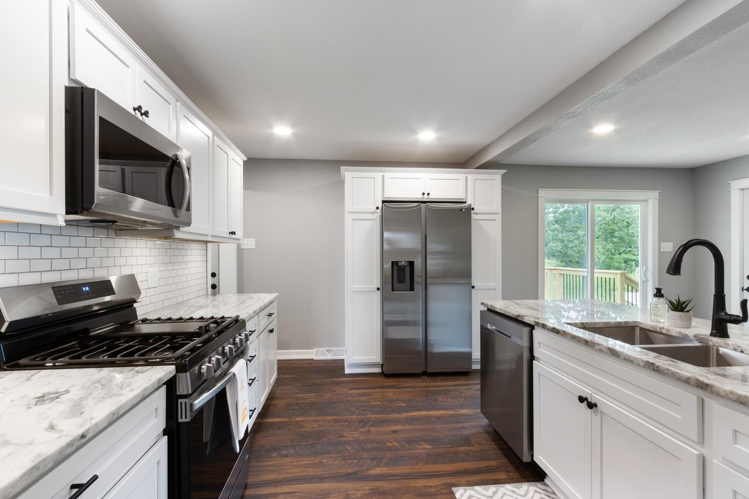2072 Highway 26 Dixon, IL 61021 - Photo 11 of 30 a kitchen with stainless steel appliances granite countertop a sink stove and refrigerator