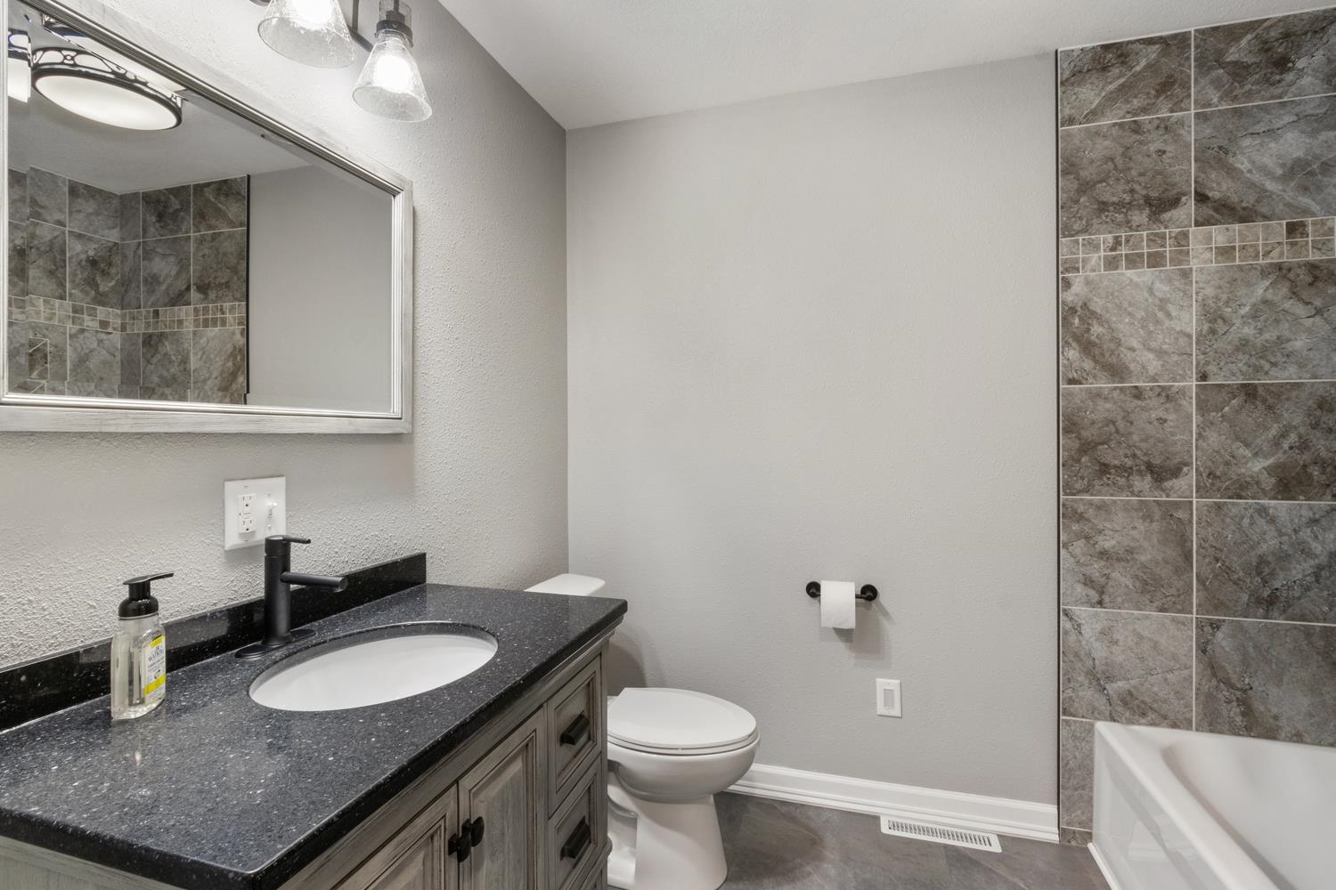 2072 Highway 26 Dixon, IL 61021 - Photo 16 of 30 a bathroom with a granite countertop sink and a mirror