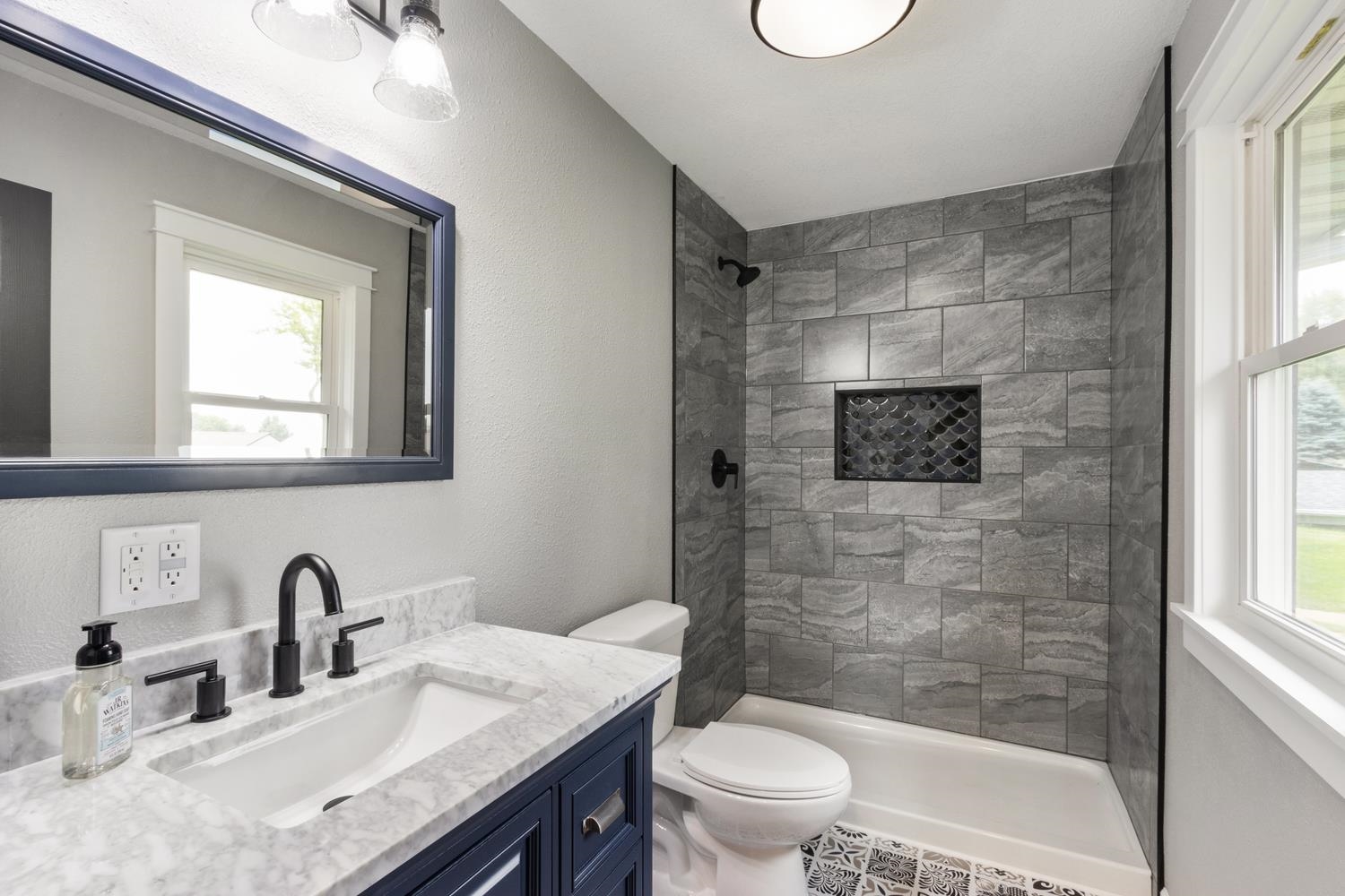 2072 Highway 26 Dixon, IL 61021 - Photo 21 of 30 a bathroom with a granite countertop sink toilet a mirror and shower