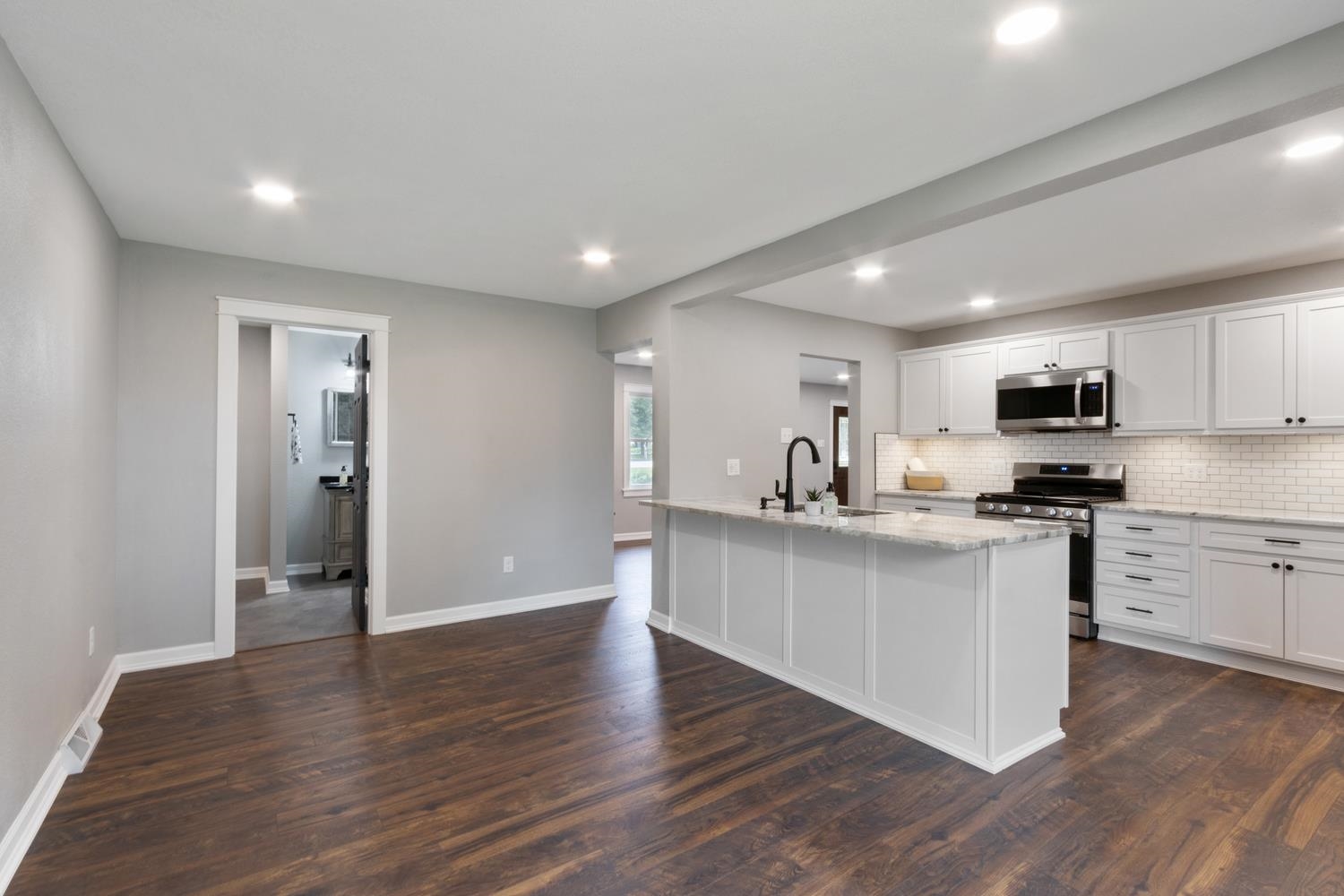 2072 Highway 26 Dixon, IL 61021 - Photo 9 of 30 a kitchen with stainless steel appliances granite countertop a refrigerator a sink dishwasher and a stove with wooden floor