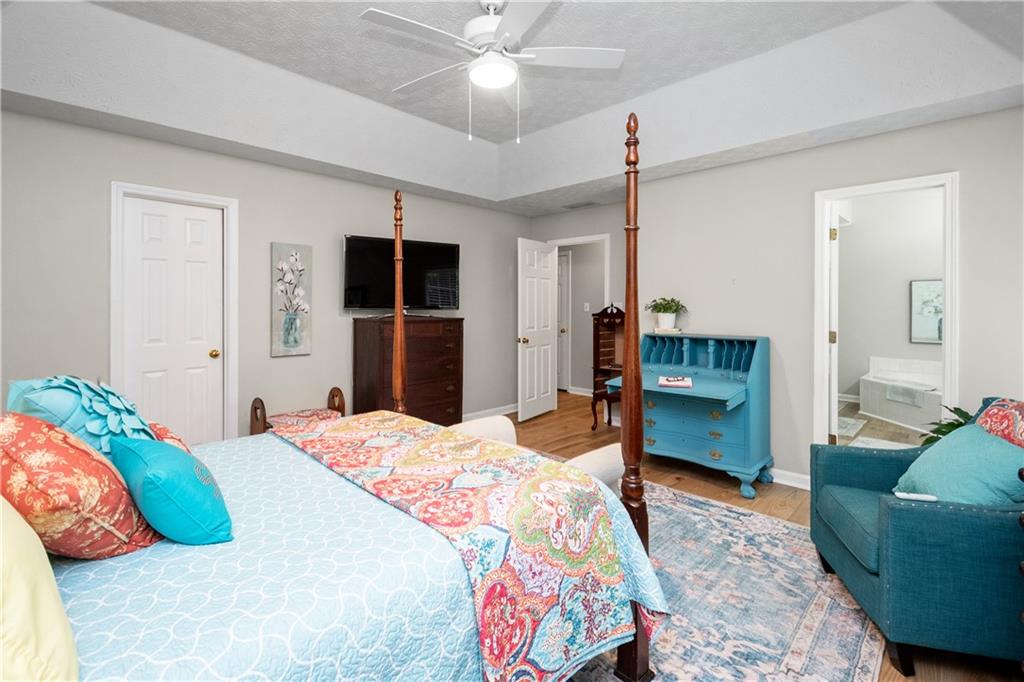 405 Ridgemont Drive Fayetteville, GA 30215 - Photo 19 of 43 a bedroom with a bed and a dresser