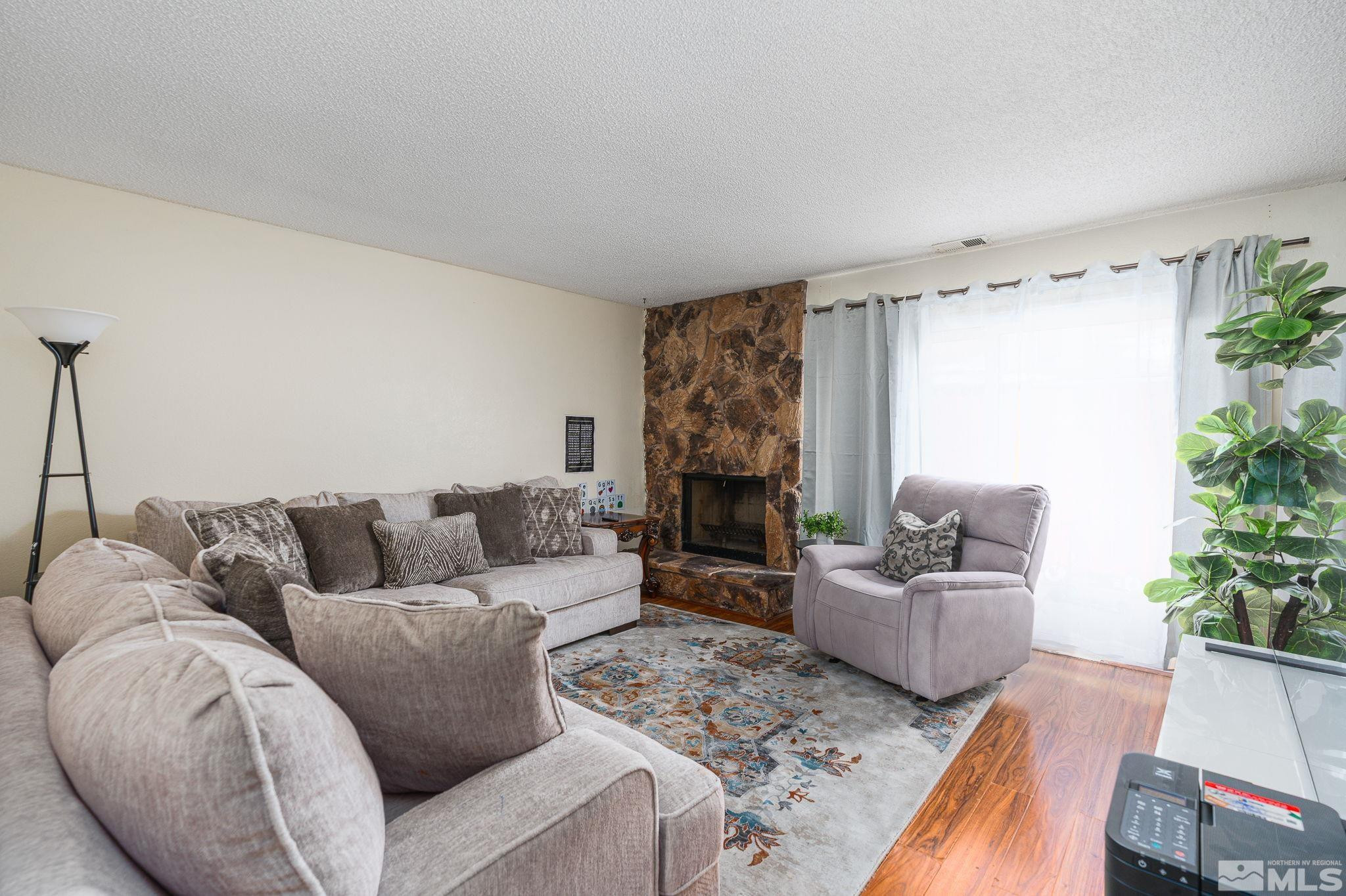 13846 Lear Boulevard Reno, NV 89506 - Photo 8 of 22 a living room with furniture and a fireplace