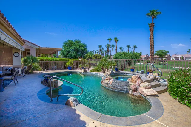 a view of a swimming pool with a patio