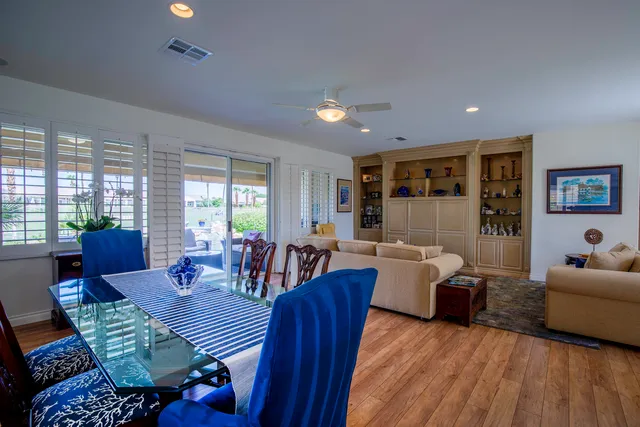 a living room with furniture dining table and a wooden floor