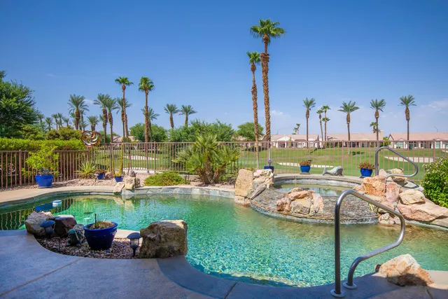 a view of a lake with couches chairs and a table of the ocean