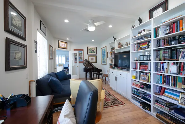 a living room with fireplace furniture and a book shelf
