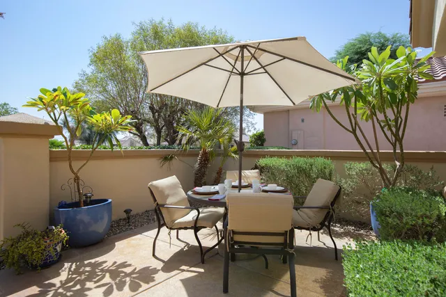 a patio with a patio table and chairs
