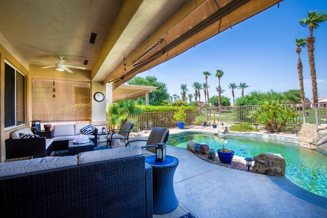 a front view of a house with garden and outdoor seating